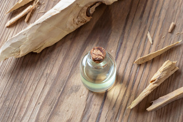 A bottle of sandalwood essential oil with white sandalwood