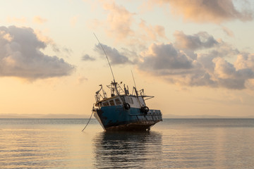 old fishing boat at sunset