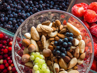 Ingredients for a healthy breakfast nuts, berries, fruits, food for heart, rich with resveratrol, vitamin, antioxidants Top view