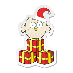 sticker of a cartoon little owl wearing christmas hat