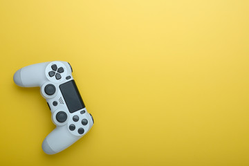 Gamepad from the game console isolated on a yellow background