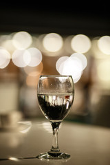 Glass glass glass with water on the background of lights