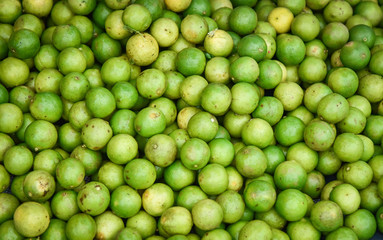 Fresh green lemon lime texture background / pile of lime for sale in the market