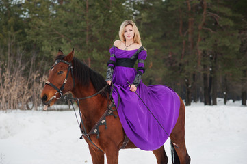 Beautiful girl in historical clothes riding a horse