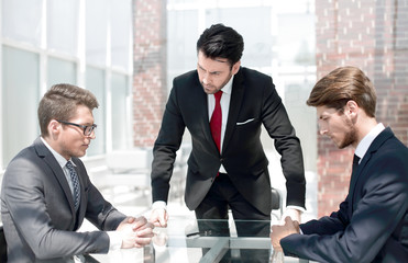 annoyed businessman talking to employees