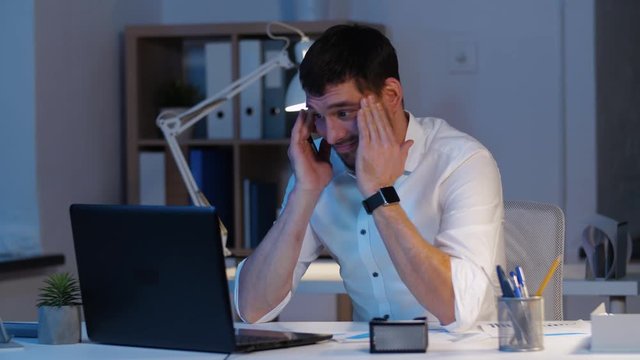 business, overwork, deadline and people concept - businessman with laptop computer working at night office