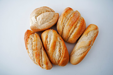 Five small different type of breads on the white background