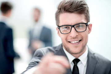 Naklejka premium close up.careful young business man in blurred background.