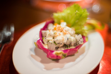 Tropical salad served in a dragonfruit skin