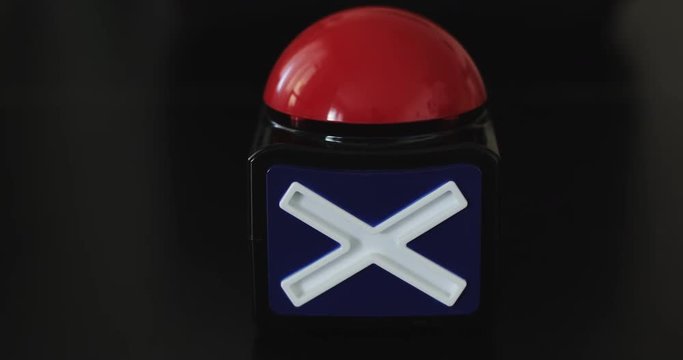 Big red button with stop inscription being pushed.