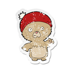 retro distressed sticker of a cartoon cute teddy bear in hat