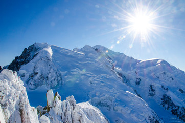 Beautiful view of Mont Blanc (in the middle), highest european mountain in french Chamonix-Mont-Blanc during winter time. Aiguille du Midi, best place for holiday, hiking and winter activities.