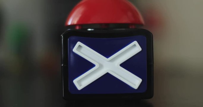 Female hand presses the red stop button.