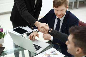 financial partners handshakes over a Desk in the office
