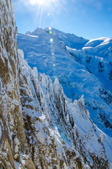 View of the highest european mountain Mont Blanc (at the back in the middle) and french Alps covered with snow. Chamonix-Mont-Blanc during winter time.