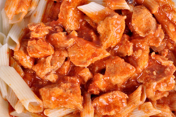 goulash with meat pieces and pasta close up