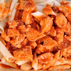 goulash with meat pieces and pasta close up