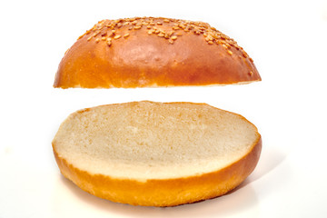 Burger bun cut in two isolated on white background
