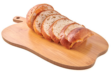 Hamburger buns cut slices on little wooden cutting board and isolated on white background