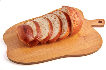 Hamburger buns cut slices on little wooden cutting board and isolated on white background