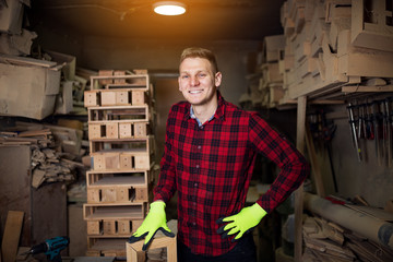 Portrait of handsome young carpenter in workshop
