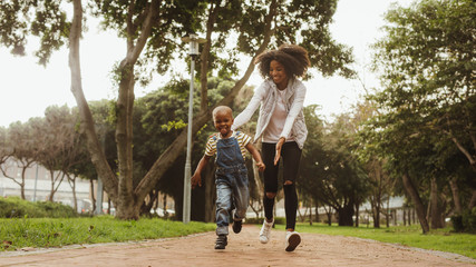 Mother running with boy in the park