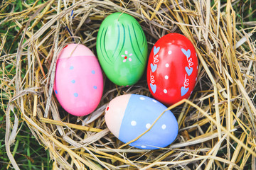 Fototapeta na wymiar Easter eggs in the nest egg colorful decorated festive tradition on green grass