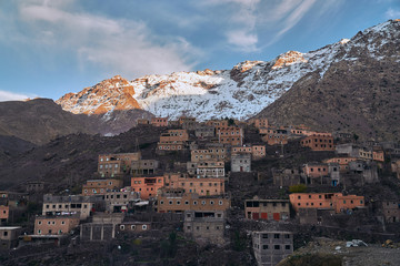 A view of sunset in rural mountain village Imlil in High Atlas mountains Morocco Africa with snow covered peaks in background