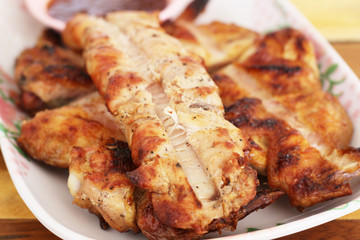 Roasted chicken in plate on wood
