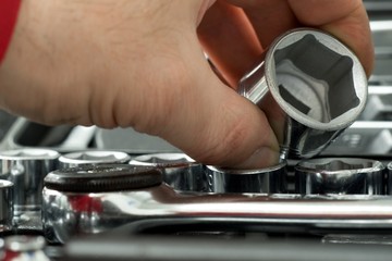 Tool repairman, mechanic tool set in the background.
