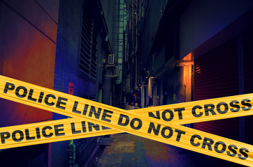 Alley in an urban area with police line or crime scene tape