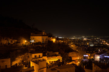 Whitewashed Houses and Cityscape in Granada, Spain as seen from Barranco del Abogado at Night - obrazy, fototapety, plakaty