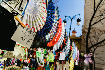 Valencia, Spain - February 24, 2019: Typical colorful Spanish flamenco fans for sale in a street market in spring.