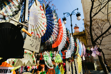 Valencia, Spain - February 24, 2019: Typical colorful Spanish flamenco fans for sale in a street market in spring.