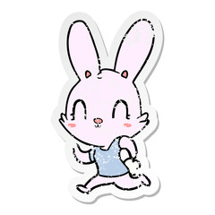 Fototapeta na wymiar distressed sticker of a cute cartoon rabbit running