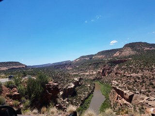 A grand view of the vast canyonlands of Western Colorado beaming in the sun under blue skies.