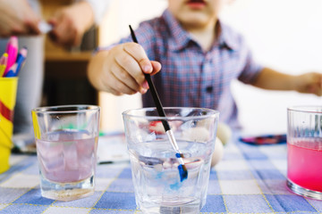 Little boy Painting Water Colors