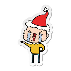 sticker cartoon of a crying bald man wearing santa hat