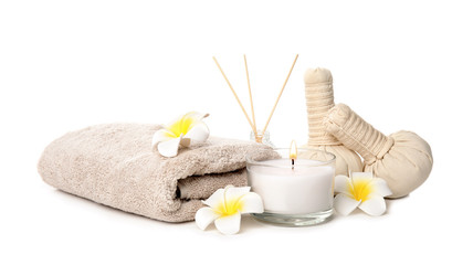Fototapeta na wymiar Beautiful spa composition with candle and herbal bags on white background