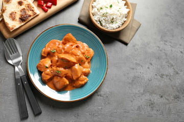Butter chicken served on grey table, top view with space for text. Traditional indian Murgh Makhani