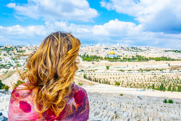 Woman is looking at Jerusalem from the mount of olives, Israel