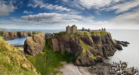 Panorama of Dunnottar Castle Medieval clifftop ruins from cliff above rocks of Old Hall Bay North...