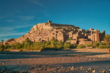 Close shot of historic unesco heritage ksar of Ait Ben Haddou in Morocco Africa with stones in the foreground