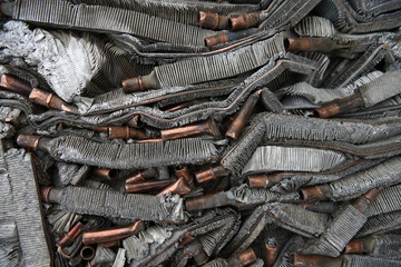 Discarded compressed, crushed aluminum and copper scrap metals for recycling.