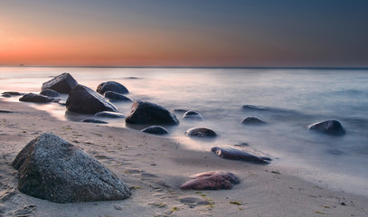 Stones in the sea at sunset