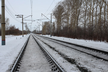 railroad rails stretching into the distance the path for the train snowbound in the winter