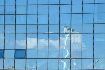 Sky and cloud reflection in windows of modern skyscrapers