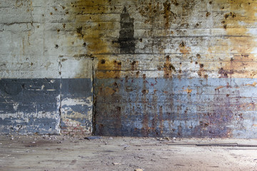 Worn out wall in an abandoned factory with bowing boards and chipping paint