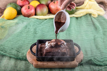 sizzling chocolate brownie is a sweet dish made using scoop of ice-cream on top served with a...