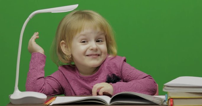 Girl drawing at the table. Education process in classroom. Happy three years old girl. Cute girl smiling. Pretty little child, 3-4 year old blonde girl. Make faces. Green screen video. Chroma Key